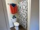 This bathroom features a toilet, shower with curtain and a towel rack at 5904 Oakton St, Las Vegas, NV 89130