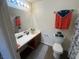 This bathroom features a vanity with cabinet, a toilet and a shower/tub at 5904 Oakton St, Las Vegas, NV 89130