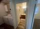 A peek into the bathroom, showing a vanity with a wood cabinet and a well-lit mirror at 5904 Oakton St, Las Vegas, NV 89130