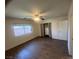 Bedroom features wood-look floors, a ceiling fan, and a window providing natural light at 5904 Oakton St, Las Vegas, NV 89130
