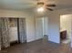 Bright bedroom features wood-look floors, a ceiling fan, and closet with attractive curtains at 5904 Oakton St, Las Vegas, NV 89130