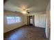 Bedroom features wood-look floors, a ceiling fan, and a closet with attractive curtains at 5904 Oakton St, Las Vegas, NV 89130