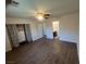 Bright bedroom features wood-look floors, a ceiling fan, and closet with attractive curtains at 5904 Oakton St, Las Vegas, NV 89130