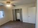 Bedroom features wood-look floors, a ceiling fan, and a closet with attractive curtains at 5904 Oakton St, Las Vegas, NV 89130