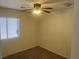 Carpeted bedroom offers a ceiling fan with light and a window at 5904 Oakton St, Las Vegas, NV 89130