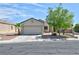 Inviting single-story home with a two-car garage and a well-manicured front yard at 5904 Oakton St, Las Vegas, NV 89130