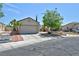 Charming single-story home featuring desert landscaping, attached garage, and a well-maintained front yard at 5904 Oakton St, Las Vegas, NV 89130