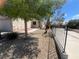 Charming single-story home with desert landscaping, mature trees, and a well-maintained fence at 5904 Oakton St, Las Vegas, NV 89130