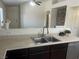 Kitchen features a double basin sink with modern faucet and a view to the living area at 5904 Oakton St, Las Vegas, NV 89130