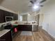 The kitchen features dark cabinets, stainless appliances, and wood-style flooring at 5904 Oakton St, Las Vegas, NV 89130