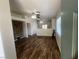 Inviting living room with wood-look flooring, a stone accent wall, and a smooth transition to the dining area at 5904 Oakton St, Las Vegas, NV 89130