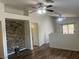 Spacious living area featuring modern ceiling fans, wood floors, and a stone accent wall for added character at 5904 Oakton St, Las Vegas, NV 89130