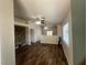 Open-concept living room with wood flooring, modern ceiling fans, and access to kitchen and outdoor space at 5904 Oakton St, Las Vegas, NV 89130