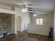 Bright living area featuring modern ceiling fans, wood floors, and a stone accent wall for added character at 5904 Oakton St, Las Vegas, NV 89130
