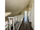 Hallway with wood floors and white banister and walls at 5928 Willard St, Las Vegas, NV 89122