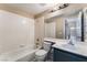 Bathroom featuring a bathtub, toilet, sink, and vanity with a large mirror at 6149 Elderberry Wine Ave, Las Vegas, NV 89142