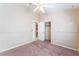 Carpeted bedroom with ceiling fan, closet, and view to a laundry room at 6149 Elderberry Wine Ave, Las Vegas, NV 89142