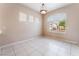 Dining room with tile floors and abundant natural light from a large window at 6149 Elderberry Wine Ave, Las Vegas, NV 89142