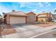 Inviting home exterior with a spacious driveway and a two-car garage, set in a neighborhood at 6149 Elderberry Wine Ave, Las Vegas, NV 89142