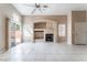 Inviting living room boasts tile flooring, fireplace, and sliding door to the backyard at 6149 Elderberry Wine Ave, Las Vegas, NV 89142