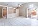 Bright living room featuring vaulted ceiling, tile flooring and sliding glass door access to the backyard at 6149 Elderberry Wine Ave, Las Vegas, NV 89142