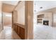 View of the living room and hallway with fireplace and white tile flooring at 6149 Elderberry Wine Ave, Las Vegas, NV 89142