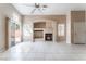 Inviting living room boasts tile flooring, fireplace, and sliding door to the backyard at 6149 Elderberry Wine Ave, Las Vegas, NV 89142