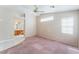 Spacious main bedroom leading to bathroom with vaulted ceilings and ceiling fan at 6149 Elderberry Wine Ave, Las Vegas, NV 89142