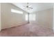 Spacious main bedroom with vaulted ceilings, ceiling fan, and carpet at 6149 Elderberry Wine Ave, Las Vegas, NV 89142