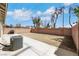 A backyard with a concrete patio, dirt yard, a barbecue and brick walls provides a canvas for outdoor customization at 6314 Shadow Moon Pl, North Las Vegas, NV 89031