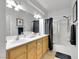 Bright bathroom featuring double sinks, spacious vanity, and a shower-tub combo for added convenience and style at 6314 Shadow Moon Pl, North Las Vegas, NV 89031