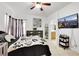 Comfortable bedroom featuring modern decor, TV, and ample closet space, enhancing the room's functionality and appeal at 6314 Shadow Moon Pl, North Las Vegas, NV 89031