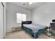 Cozy bedroom features a ceiling fan, window with blinds, closet and includes a bed and desk at 6314 Shadow Moon Pl, North Las Vegas, NV 89031