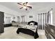 Charming bedroom featuring mirrored closet doors and a decorative ceiling fan for added comfort and elegance at 6314 Shadow Moon Pl, North Las Vegas, NV 89031