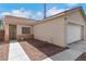 Inviting single-story home showcasing a two-car garage, neutral exterior, and a tidy gravel yard at 6314 Shadow Moon Pl, North Las Vegas, NV 89031