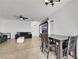 Open living room area showing modern decor, tile floors, and seamlessly integrates living and dining spaces at 6314 Shadow Moon Pl, North Las Vegas, NV 89031