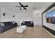 Bright living room with modern ceiling fan and a large decorative television at 6314 Shadow Moon Pl, North Las Vegas, NV 89031