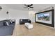 Bright living room with modern ceiling fan and a large decorative television at 6314 Shadow Moon Pl, North Las Vegas, NV 89031