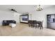Bright living room featuring tile flooring, modern lighting, and an entertainment center with large screen TV at 6314 Shadow Moon Pl, North Las Vegas, NV 89031
