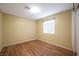 A clean and simple bedroom with laminate floors and natural light from a window at 635 Dry Valley Ave, North Las Vegas, NV 89031