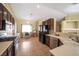 Spacious kitchen with stainless steel appliances, dark cabinets, and a view of the living area at 635 Dry Valley Ave, North Las Vegas, NV 89031