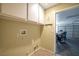 Functional laundry area with storage cabinets and convenient access to the garage at 635 Dry Valley Ave, North Las Vegas, NV 89031