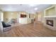 Open-concept living area featuring wood floors, a cozy fireplace, and seamlessly connects to the kitchen at 635 Dry Valley Ave, North Las Vegas, NV 89031