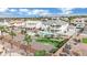 Aerial view of a neighborhood with homes, pools, desert landscaping, and mountain views at 6927 Adobe Villa Ave, Las Vegas, NV 89142