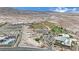 An aerial view showcases community ball fields, school and aquatics area with desert mountain backdrop at 6927 Adobe Villa Ave, Las Vegas, NV 89142