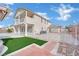 Expansive backyard with artificial turf, a pool, and a fenced perimeter for privacy at 6927 Adobe Villa Ave, Las Vegas, NV 89142