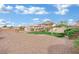 Expansive backyard features rock landscaping, a grassy area, and a covered patio at 6927 Adobe Villa Ave, Las Vegas, NV 89142