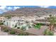 Beautiful backyard with a pool, pergola, lush greenery, and desert landscaping for outdoor enjoyment at 6927 Adobe Villa Ave, Las Vegas, NV 89142