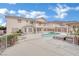 Spacious backyard with a pool, outdoor pergola, well-manicured landscaping, and mountain views at 6927 Adobe Villa Ave, Las Vegas, NV 89142