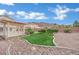 Lush backyard showcasing a covered patio and rock landscaping at 6927 Adobe Villa Ave, Las Vegas, NV 89142